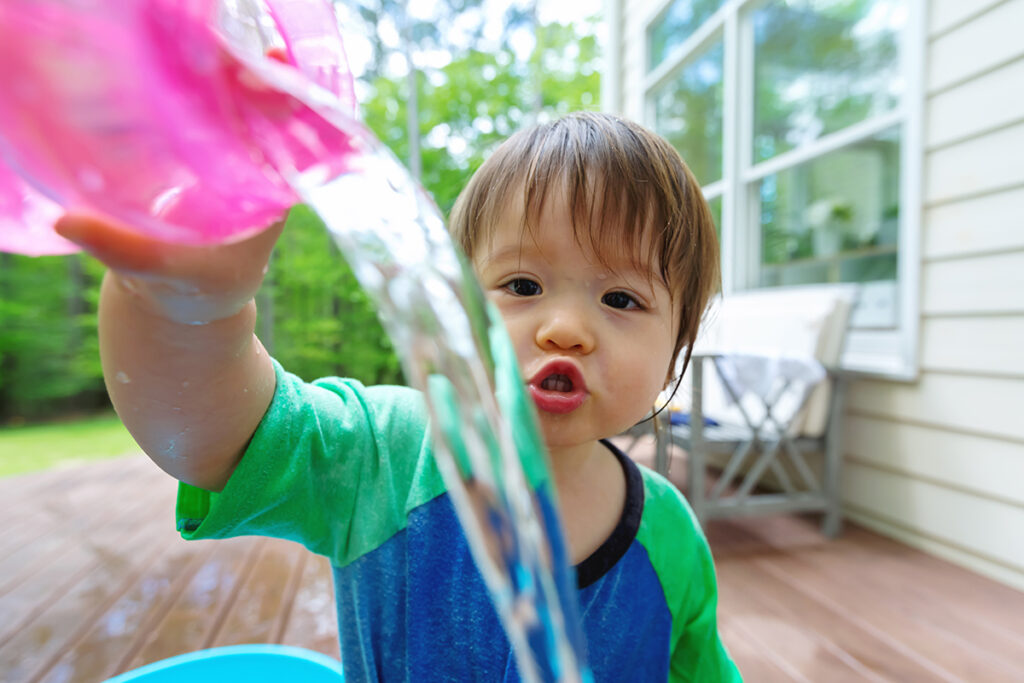 toddler boy during water out of cup